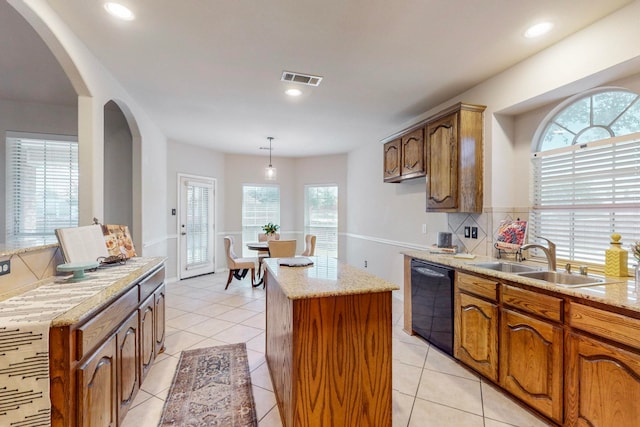 kitchen with dishwasher, pendant lighting, light tile patterned floors, a center island, and sink