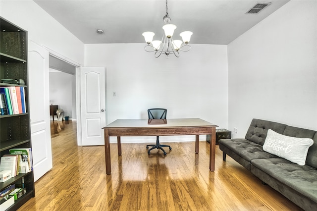 office area featuring a chandelier and hardwood / wood-style flooring