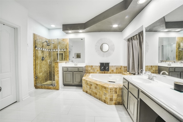 bathroom with tile patterned flooring, vanity, and independent shower and bath