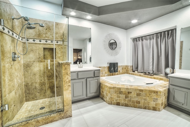 bathroom with tile patterned floors, vanity, and shower with separate bathtub