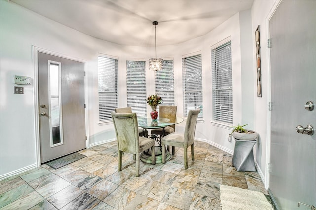 dining area featuring a chandelier and a healthy amount of sunlight