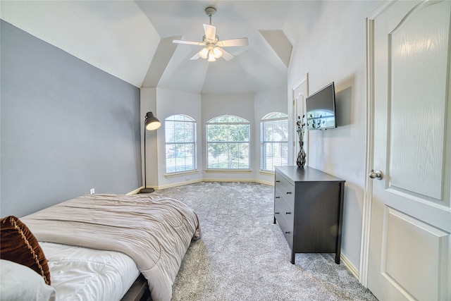 carpeted bedroom with ceiling fan and vaulted ceiling