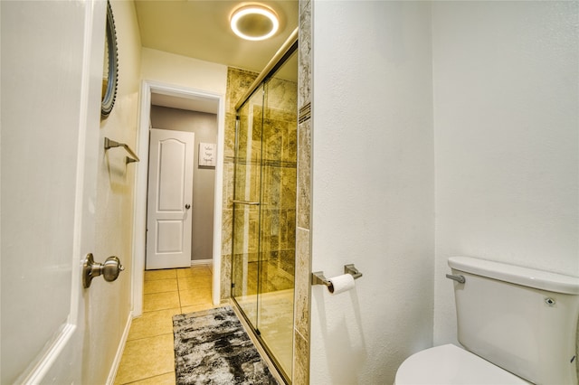 bathroom featuring tile patterned floors, walk in shower, and toilet