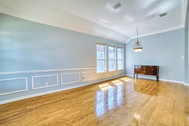 unfurnished room with crown molding, light hardwood / wood-style floors, and lofted ceiling