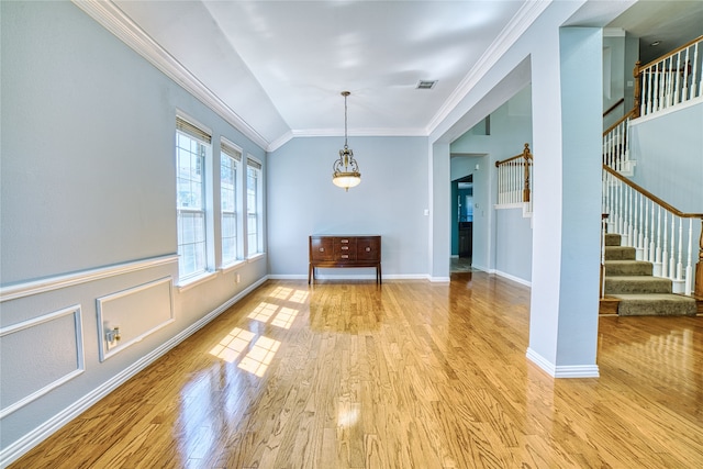 unfurnished dining area with light wood-type flooring and crown molding