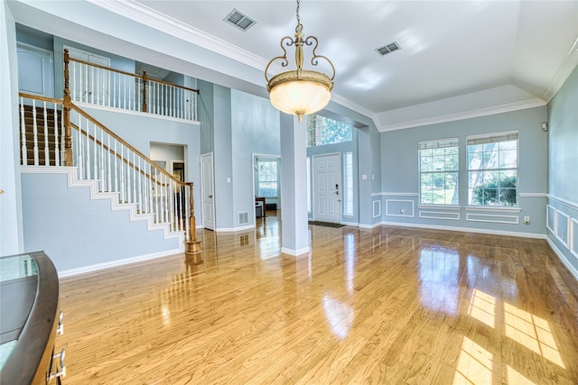 unfurnished living room featuring light wood-type flooring and ornamental molding