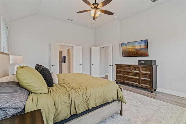 bedroom featuring ceiling fan, high vaulted ceiling, and light wood-type flooring