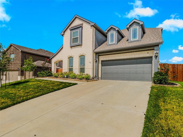 view of front of house featuring a garage and a front yard