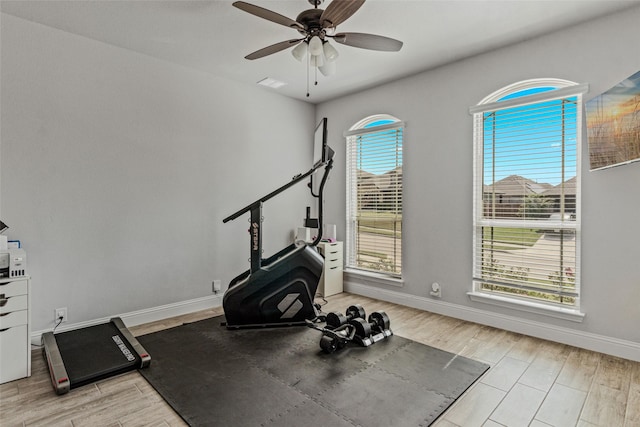 workout area with visible vents, ceiling fan, baseboards, and wood tiled floor