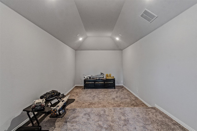 interior space with vaulted ceiling, baseboards, visible vents, and carpet floors