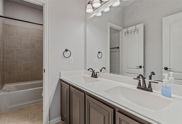 full bath with double vanity, tub / shower combination, tile patterned floors, and a sink