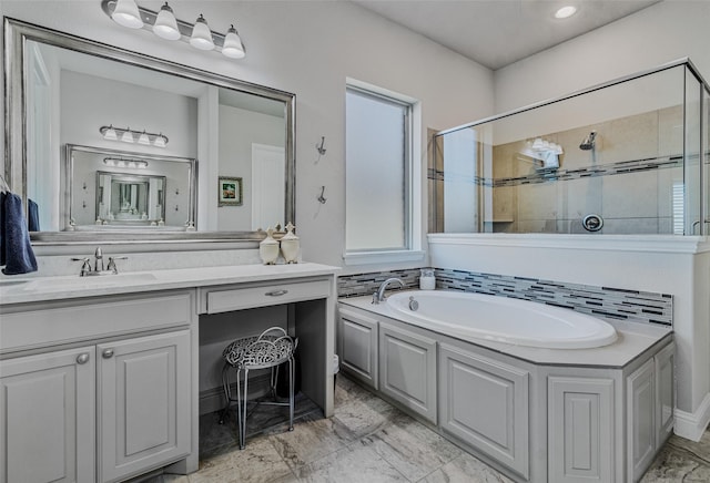 bathroom with vanity, shower with separate bathtub, and decorative backsplash