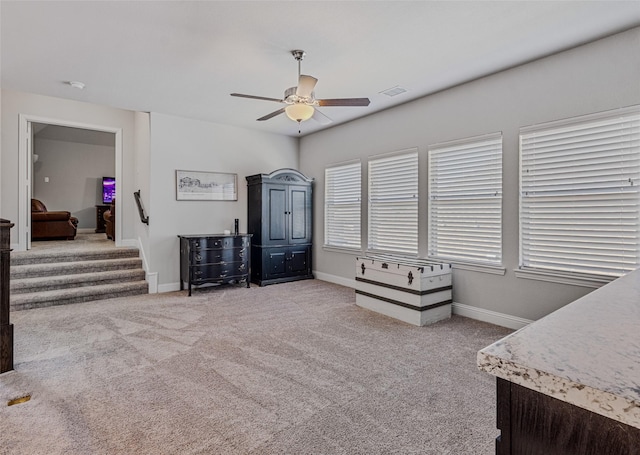 miscellaneous room featuring light carpet and ceiling fan