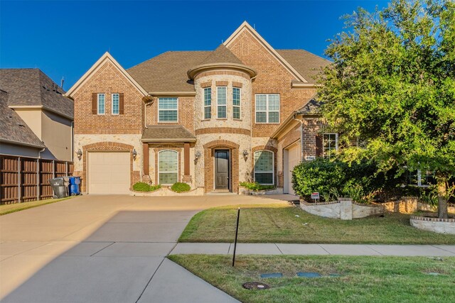 view of front of house with a garage and a front lawn