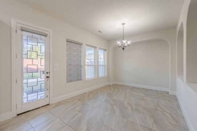 interior space with a wealth of natural light, an inviting chandelier, and light tile patterned flooring