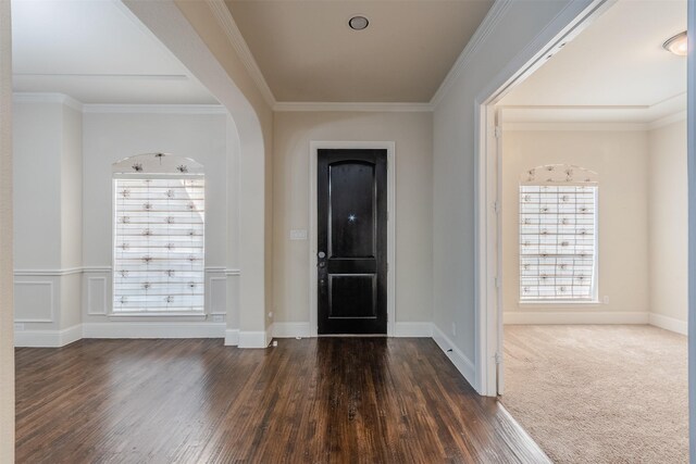 foyer with dark hardwood / wood-style floors and ornamental molding