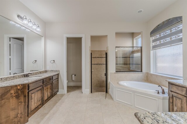 full bathroom featuring shower with separate bathtub, tile patterned flooring, plenty of natural light, and vanity