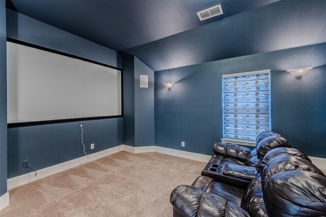 carpeted home theater room featuring lofted ceiling