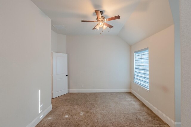 unfurnished room with light carpet, vaulted ceiling, and ceiling fan