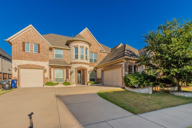 view of front of house with a garage and a front lawn