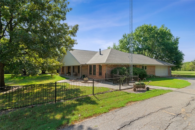 ranch-style home with a garage and a front lawn