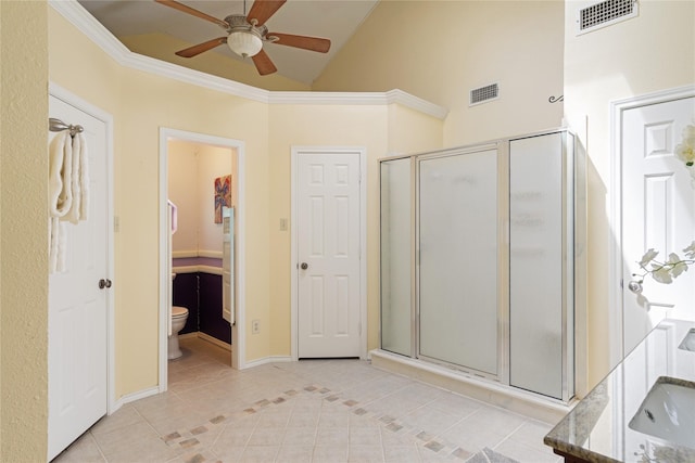 bathroom with vaulted ceiling, ceiling fan, tile patterned flooring, and a shower with door