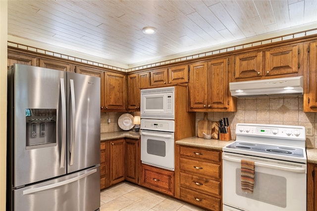 kitchen with tasteful backsplash, light tile patterned floors, wood ceiling, and white appliances