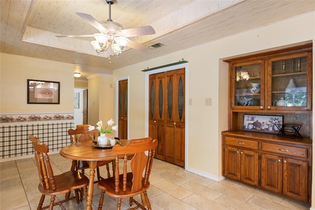 tiled dining room featuring wood ceiling and ceiling fan