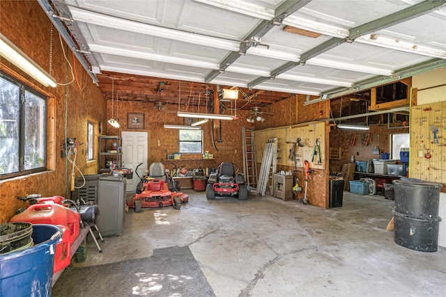 garage with a garage door opener and a workshop area