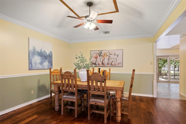 dining space with hardwood / wood-style floors, ceiling fan, a wood stove, and crown molding