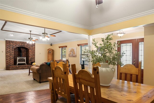 dining space featuring crown molding, lofted ceiling, ceiling fan, and dark hardwood / wood-style floors