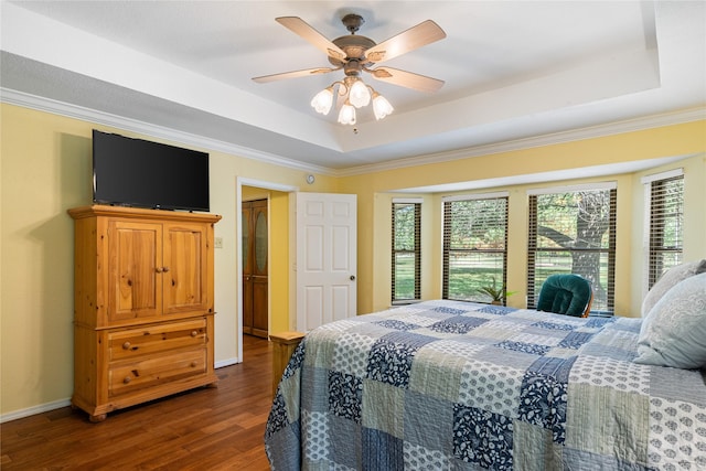 bedroom featuring ornamental molding, a raised ceiling, ceiling fan, and dark hardwood / wood-style floors