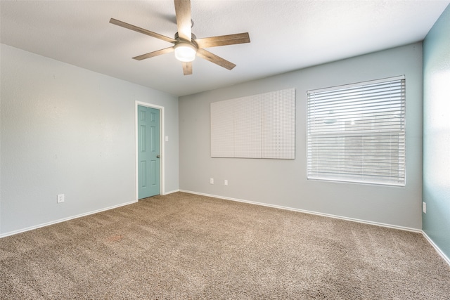 carpeted empty room featuring ceiling fan