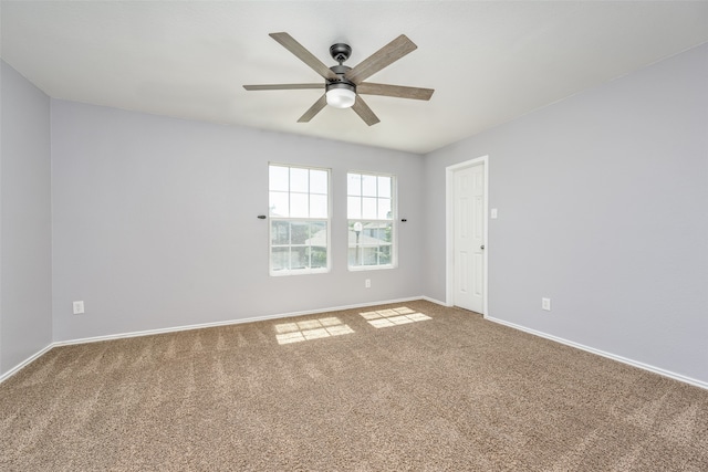 spare room featuring carpet and ceiling fan