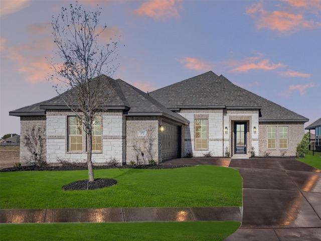 view of front facade with a lawn and a garage