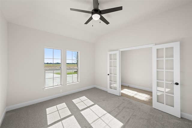 unfurnished bedroom featuring french doors, carpet floors, ceiling fan, and lofted ceiling