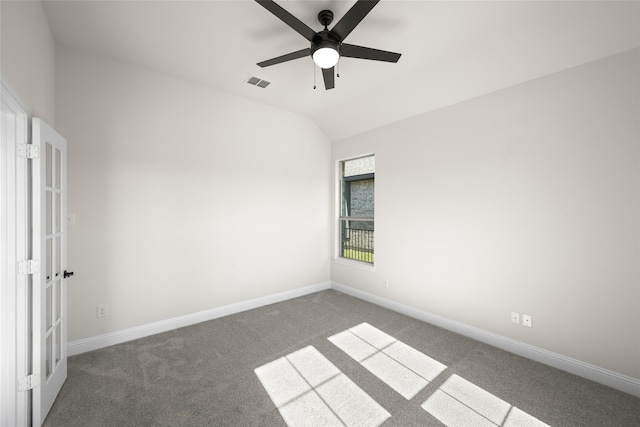 carpeted empty room with ceiling fan and vaulted ceiling