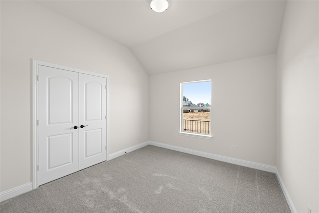 interior space with carpet and lofted ceiling