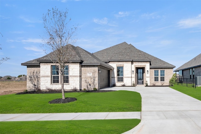 view of front of home with cooling unit, a garage, and a front lawn