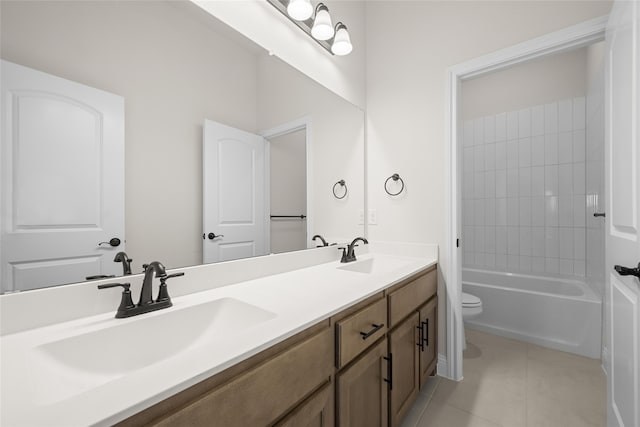 full bathroom featuring tile patterned floors, vanity, toilet, and tiled shower / bath