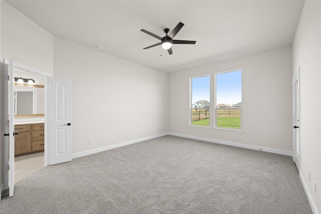 spare room featuring ceiling fan and light colored carpet