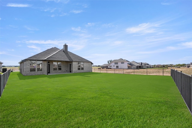 rear view of property featuring a lawn