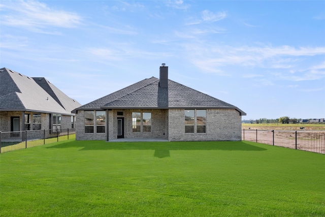 rear view of house featuring a yard