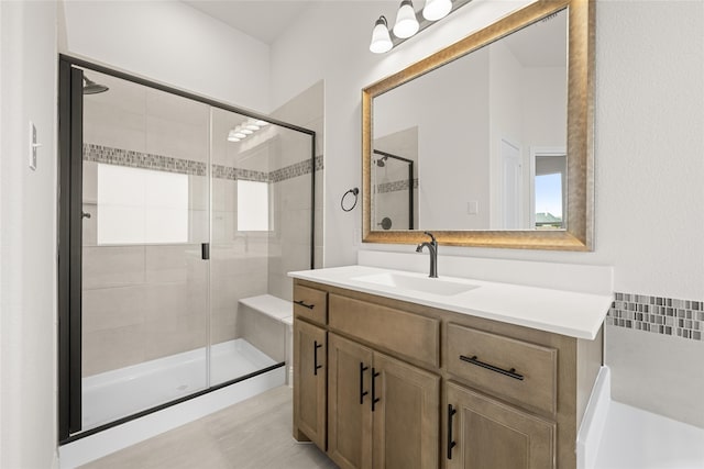 bathroom with vanity and a shower with shower door