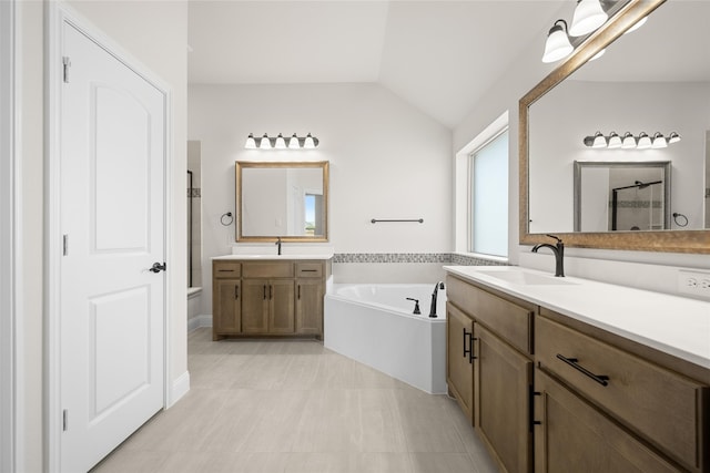 bathroom featuring tile patterned floors, vanity, separate shower and tub, and lofted ceiling