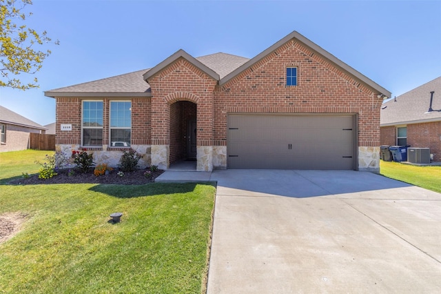 view of front of house featuring a front yard, driveway, brick siding, and stone siding