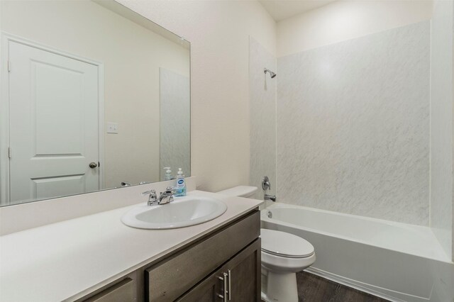 full bathroom with vanity, toilet, wood-type flooring, and bathtub / shower combination