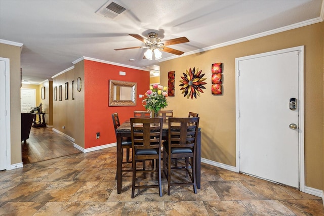 dining space featuring ceiling fan and ornamental molding