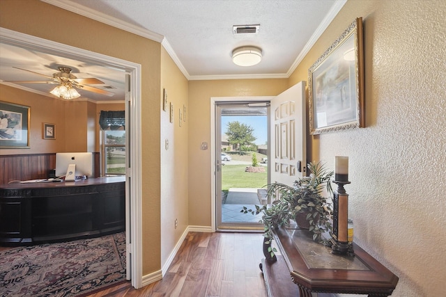 doorway featuring ceiling fan, crown molding, a textured ceiling, and hardwood / wood-style floors