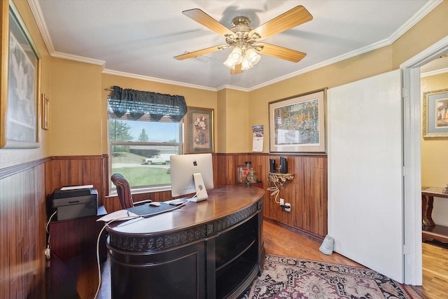 office space featuring ceiling fan, ornamental molding, and light hardwood / wood-style flooring